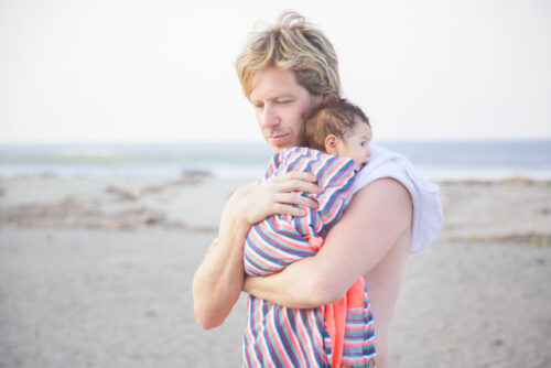 A person spending time outside with their baby.