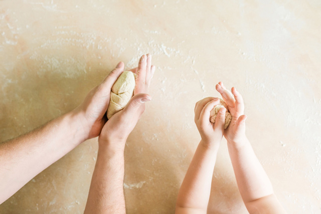 parent and child kneading dough