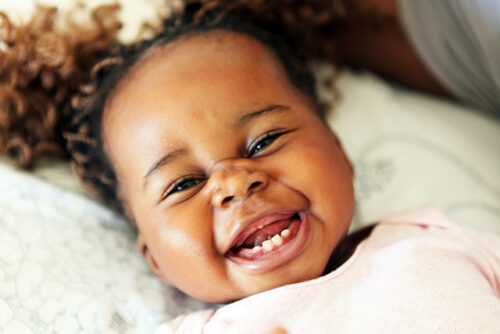 baby smiling with teeth