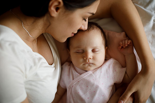 woman napping with baby