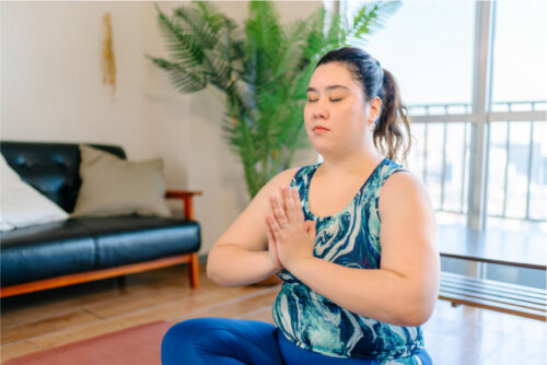 A person meditating in a room .
