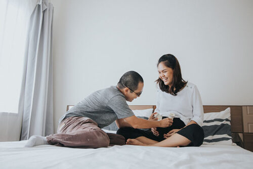pregnant couple with baby socks
