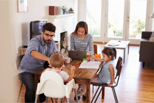 Busy young family sitting at a table