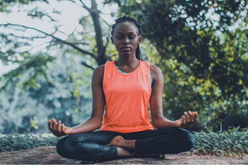 A person meditating outdoors as part of their daily routine.