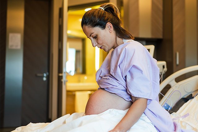 Pregnant woman on hospital bed