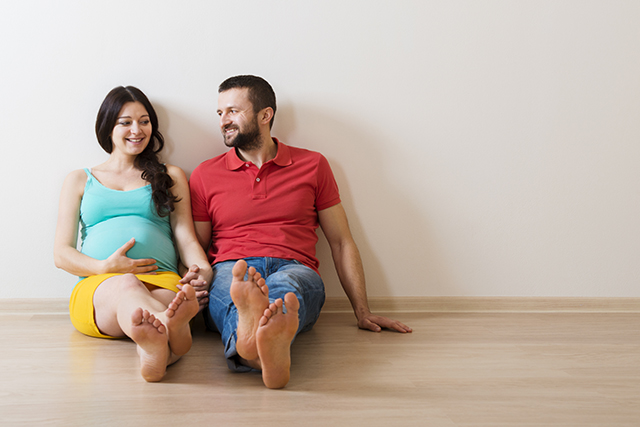 Pregnant couple sitting on the floor