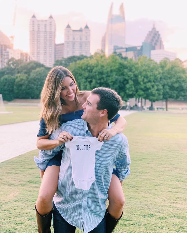 Couple holding onesie