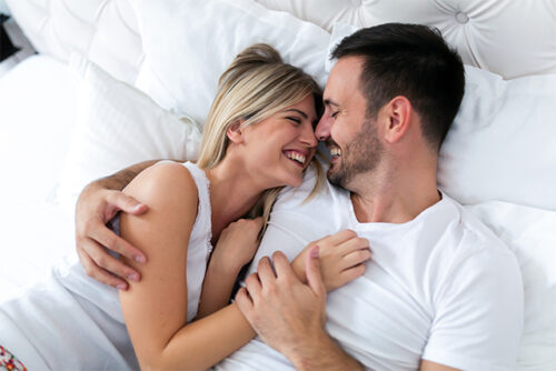 This image represents a person talking about sex with their partner while laying in bed.