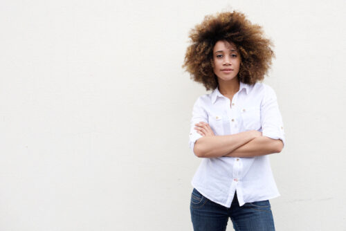 A woman standing with arms crossed to represent understanding common fertility myths.