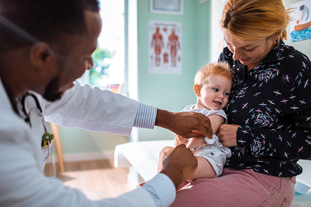 child getting a shot at doctors office