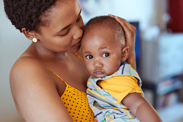 mom kissing baby