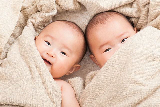 twins wrapped in blankets