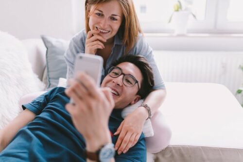 A couple looking at their phone looking up information on how to track the fertile window.
