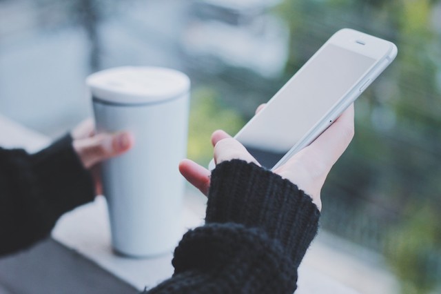 A person using their phone to track moods when trying to conceive