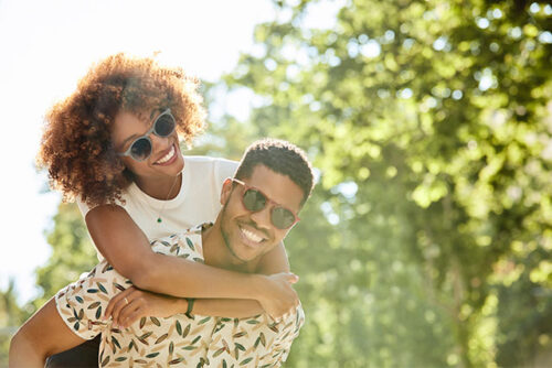 A smiling couple to represent how to talk to your partner about kids.