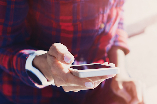 A person looking up on their phone how to track their menstrual phase.