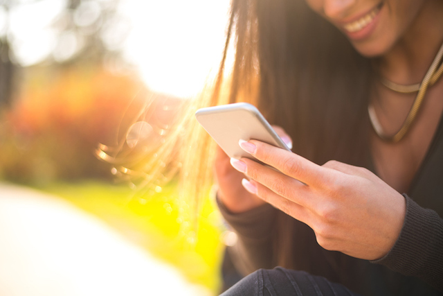 A person using their fertility tracker app from Ovia Health.