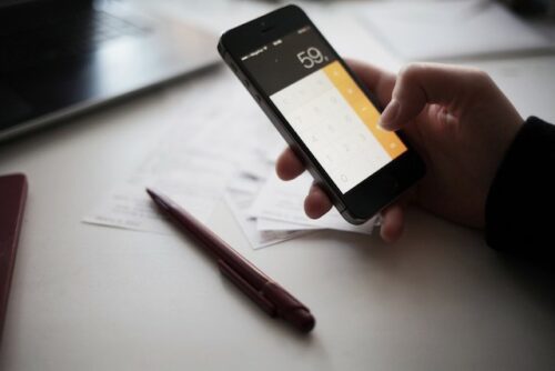 A person using the calculator on their phone to calculate fertility treatment costs