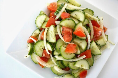A plate of cucumber tomato salad.