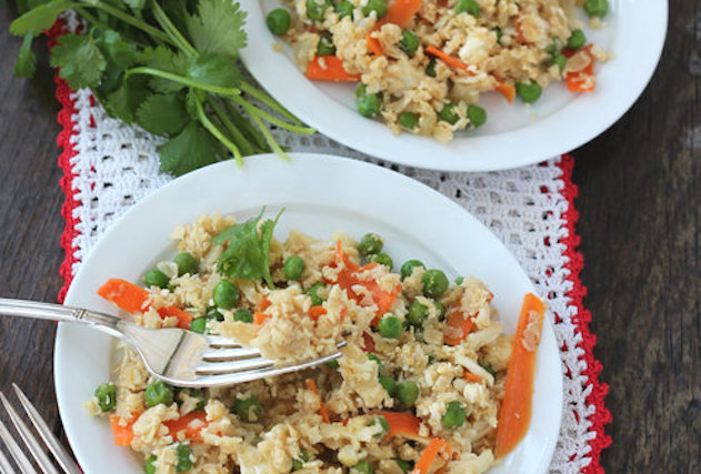 Two plates of cauliflower rice with vegitables.