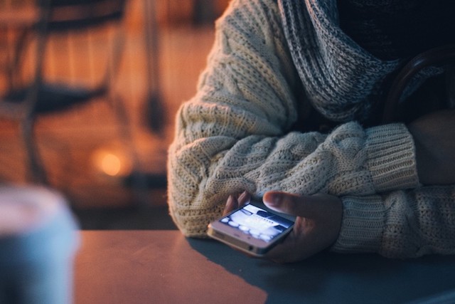 A person on their cell phone looking up causes of infertility.