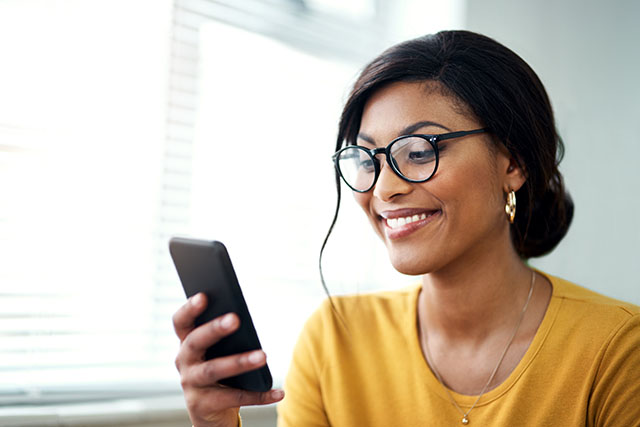 A woman on phone looking up information about a conception tracker.