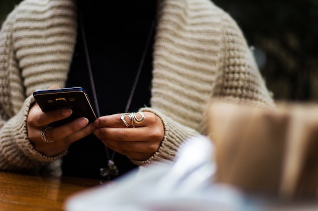 A person looking up signs of PCOS on their cellphone.