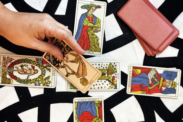A person dealing fortune cards.