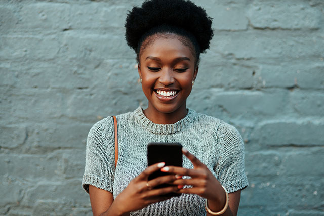 A woman holding phone looking up information on how to track fertility.