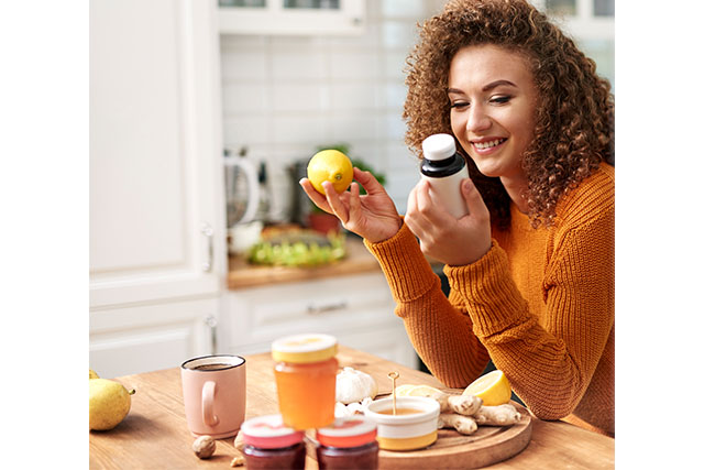 A woman looking at vitamins and other supplements that may help boost her fertility.