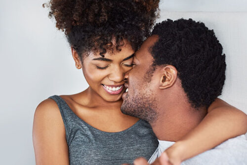 A happy couple kissing.