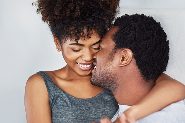 A happy couple kissing.