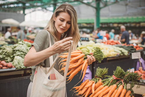 A woman buying healthy foods.