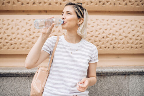 A woman drinking water.
