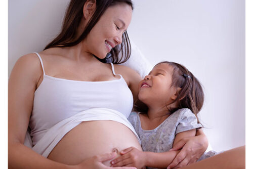 A pregnant woman and her young child.