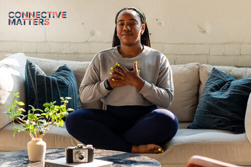 woman holds her heart in meditation