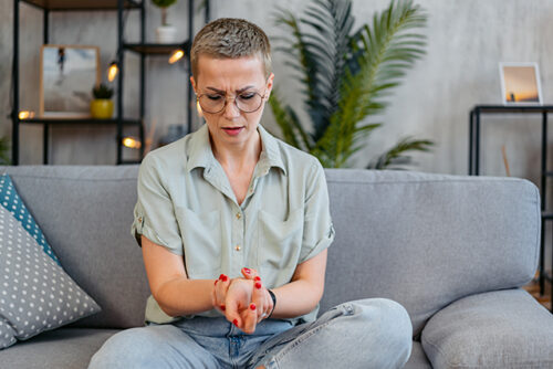 woman holds her wrist