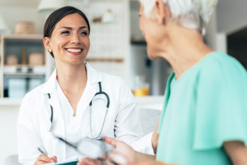 Doctor smiles while looking at patient