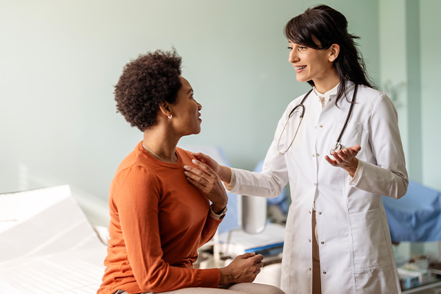 woman speaks to healthcare provider