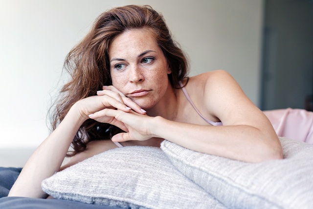 woman laying on pillows