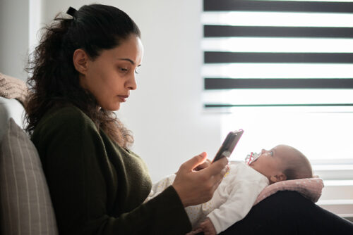 Woman looks at phone