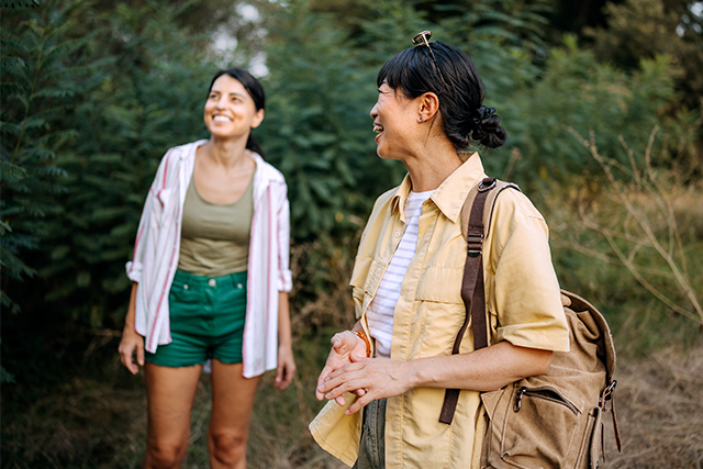 two women walking outdoors.