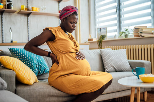 pregnant person holding their belly