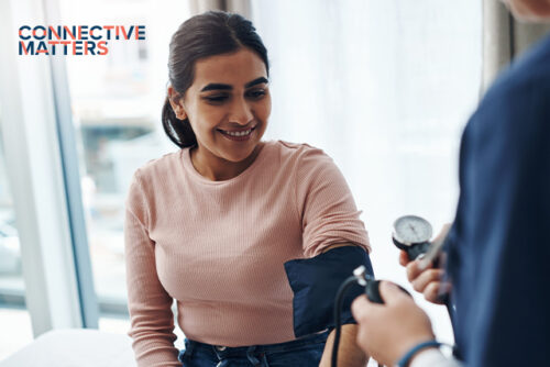 woman getting her blood pressure checked