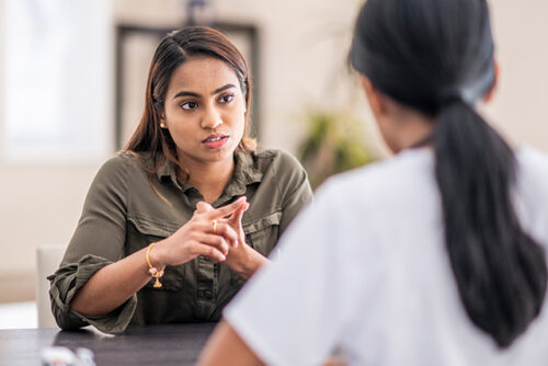 Woman speaking intently with another woman
