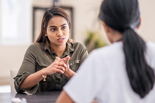 Woman speaking intently with another woman