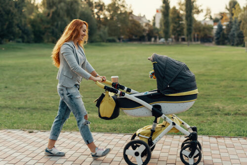 woman pushing baby carriage
