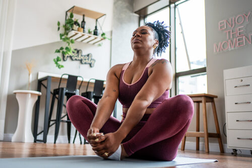 woman exercising/stretching at home