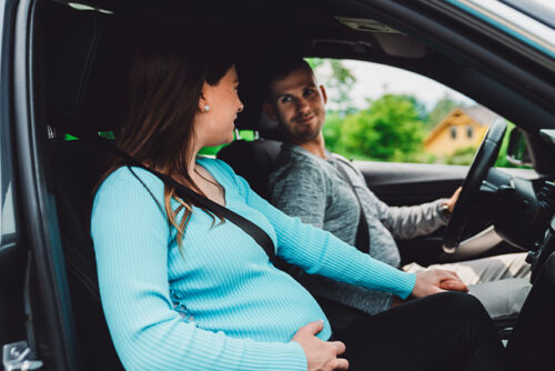 pregnant person and partner in a car