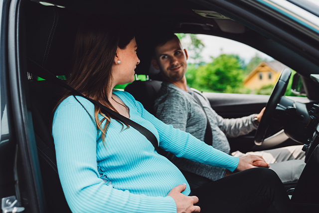 pregnant person and partner in a car